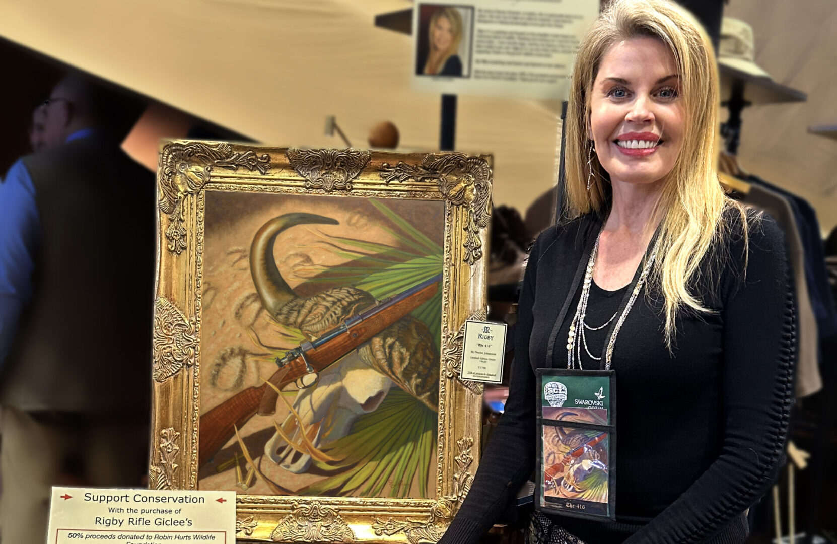 A woman standing next to a painting of a bird.