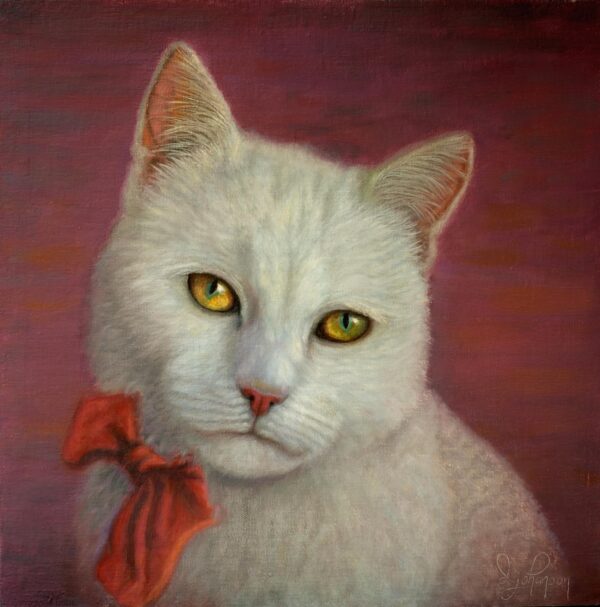 A white cat with orange bow tie sitting on top of a pink wall.